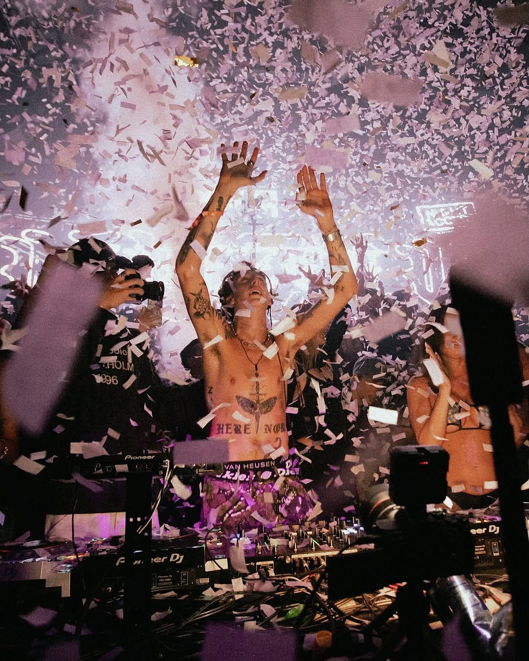 People dancing while confetti is dropping