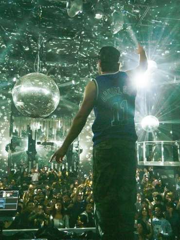 A DJ facing the crowd dancing