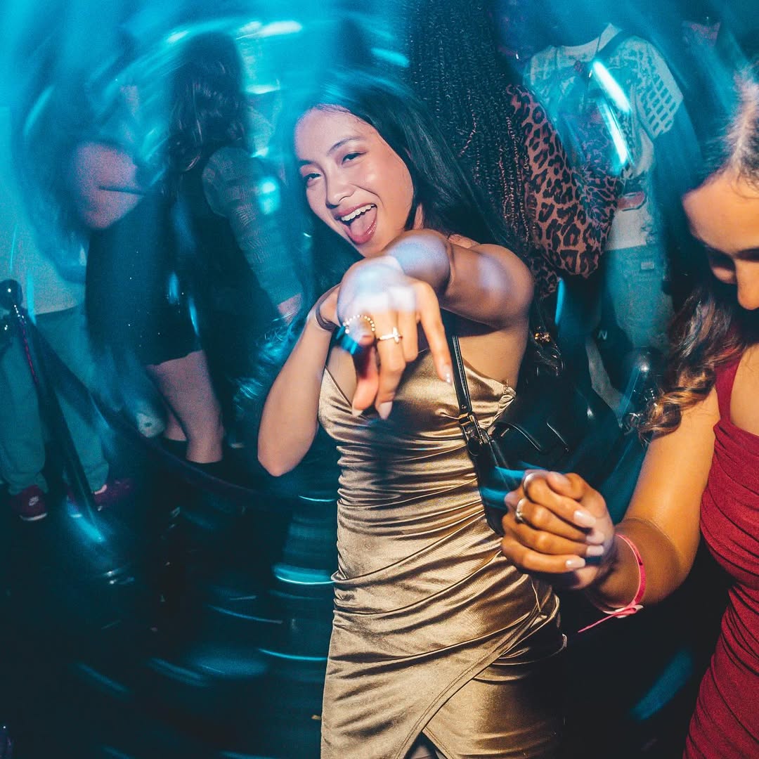 Woman partying, pointing at the camera